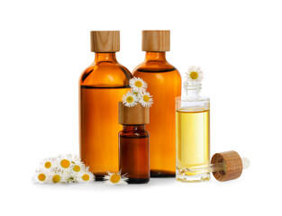 Bottles of chamomile essential oil and flowers on white background