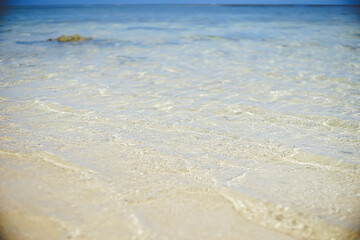 Fototapeta na wymiar 日本沖縄県の離島宮古島の青い海 波打ち際 美しい砂浜のビーチ