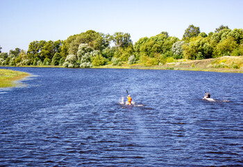Athletes in kayaks, kayaks, canoes. Sports rowing on the river.