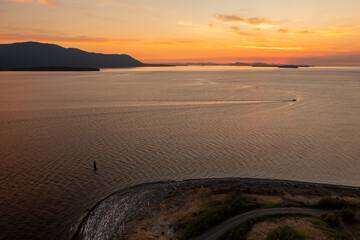 Aerial View of a Pleasure Boat Cruising the San Juan Islands at Sunset. During a glorious sunset a...