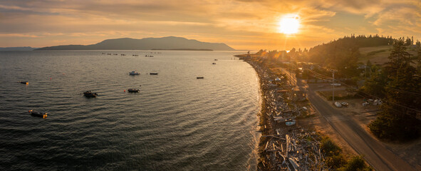 Aerial Sunset View of the West Side of Lummi Island, Washington. he sun is setting over the San...
