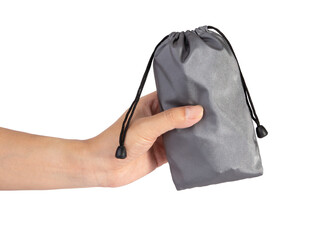 Hand holding a silver color drawstring pouch mockup isolated on white background.