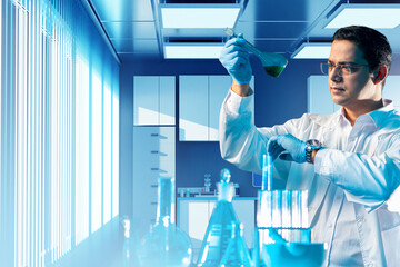 Man is chemist. Guy in white coat in laboratory. Chemist holds test tube in front of him. Laboratory of chemical enterprise. Chemist measures time by studying reaction. Chemical analysis. Art focus.