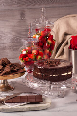 Chocolate cake in pastry display decorated with cocoa and strawberries, keto recipe