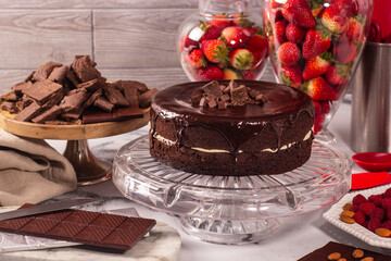 Chocolate cake in pastry display decorated with cocoa and strawberries, keto recipe