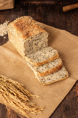 whole wheat baking bread with grains for healthy eating on wood table in kitchen