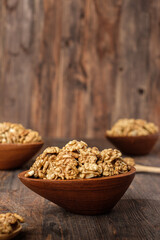 walnut in wood bowl on kitchen table
