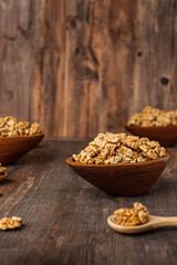 walnut in wood bowl on kitchen table