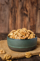 walnut in ceramic bowl on kitchen wooden table