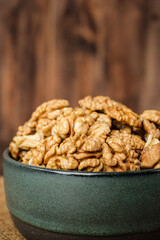 walnut in ceramic bowl on kitchen wooden table