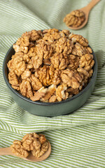 wallnut in ceramic bowl on green tablecloth in kitchen