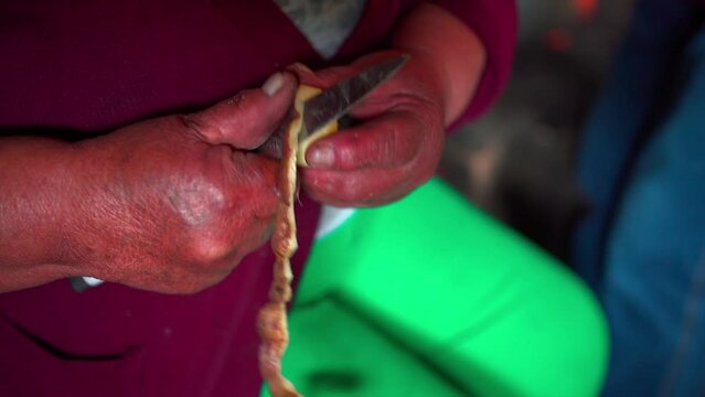 peasant woman peeling a potato