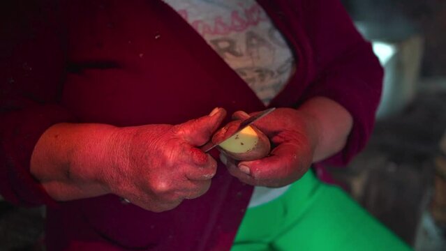 peasant woman peeling a potato

