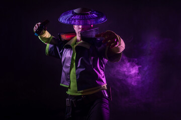 Cyborg killer in an Asian hat, a futuristic character in a fighting pose, falls backwards. Cyber style, purple backlight and black background