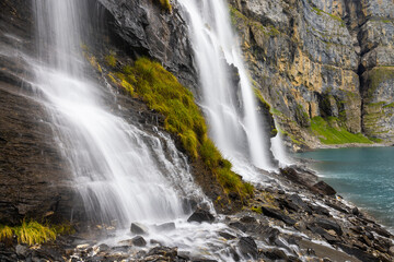 Fototapeta na wymiar Mystic waterfall at Lake Oeschinen in the Bernese Alps, Switzerland 