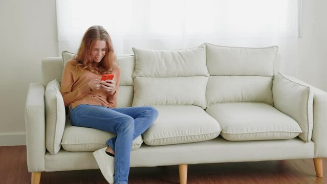 Young woman use the phone to Online learning or shopping online.