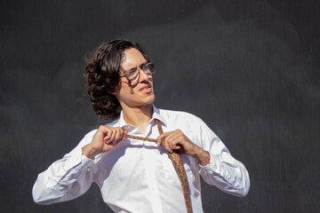 Handsome and elegant Latin American young man poses outdoors and smiles attentively in Venezuela