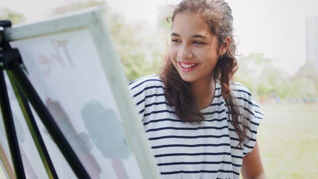 young women artist are drawing pictures as an outdoor hobby.