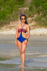 Obraz premium Woman with swimsuit stand relax in morning at beach
