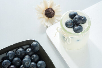 yogurt with fresh blueberry on a white background. healthy cereal morning breakfast, Top view
