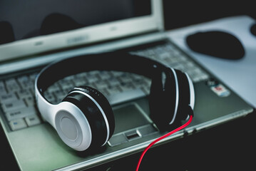 headphone and laptop working, dark background