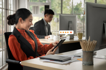 Young Asian happy woman using smartphone ,customer service and five stars satisfaction rating.