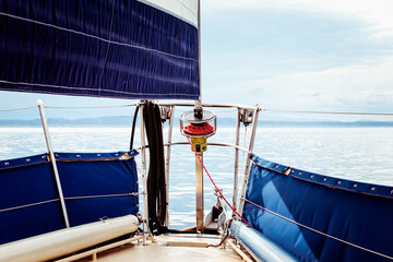 Foresail and tip of a sailbaot on a tranquil day on the water