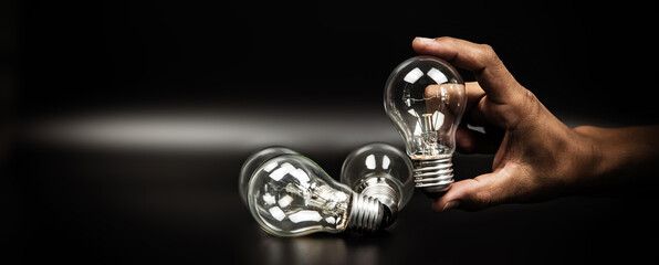 Close up hand choose light bulb or lamp for human resources or leadership and creativity thinking...