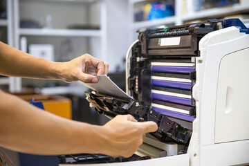 Technician hand open cover photocopier or photocopy to fix copier paper jam and replace ink...