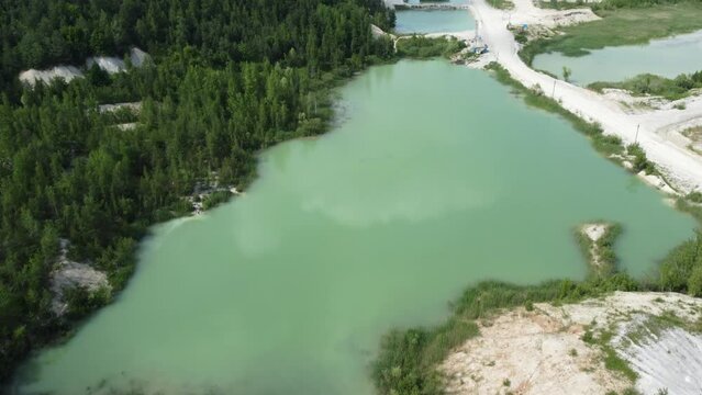Quarry lakes in abandoned kaolin pit among forest, aerial view