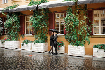 Sweet couple boy and girl hugging in the rain. Concept of love, romance and passion.