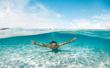 Man swimming in crystal clear water