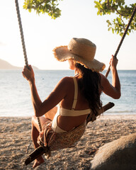 Woman on a swing on the beach - Fitzroy Island