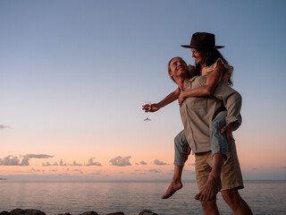 Couple enjoying a glass of champagne with the sunset - rex smeal park, port douglas, queensland.