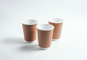 Coffee cups on a white background. Disposable dishes for hot drinks. Logo model.