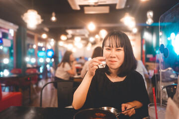 Portrait of drunk asian woman drinking soju or sake at alcohol korean bar restauran