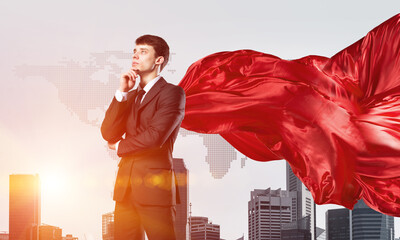 Concept of power and sucess with businessman superhero in big city