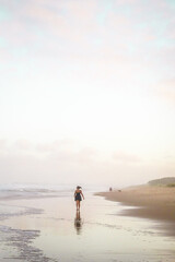 Fototapeta na wymiar couple walking on the beach at sunset