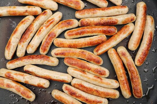 lots of delicious fried sausages in the pan 
