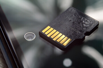 micro sd card lies on the smartphone screen. close-up