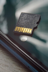 micro sd card lies on the smartphone screen. close-up