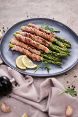 Healthy food - Asparagus wrapped with bacon and spices on a plate