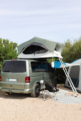 a new gray camper van with a roof tent