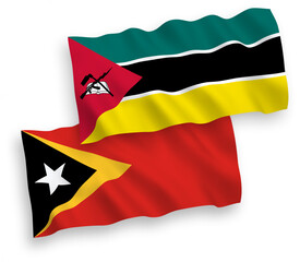 National vector fabric wave flags of Republic of Mozambique and East Timor isolated on white background. 1 to 2 proportion.