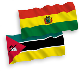 National vector fabric wave flags of Republic of Mozambique and Bolivia isolated on white background. 1 to 2 proportion.