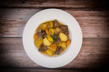 Recipe for beer and mustard beef chuck stew with potatoes, turnips and carrots, High quality photo