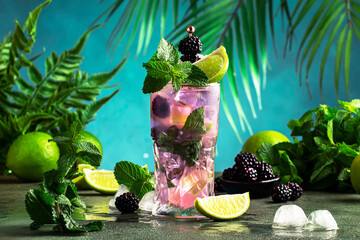 Blackberry mojito, summer alcoholic cocktail with white rum, soda, lime, mint, ice and berries....