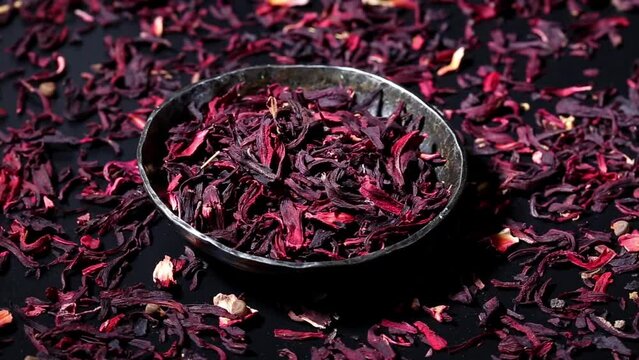 Dried leaves of hibiscus red dry tea background, close up. rotation.