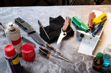 A variety of knives and tools in the service center. Tool maintenance and care. Tools and oil.