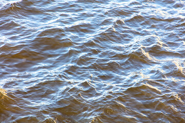 Wavy surface of water in a reservoir as an abstract background.